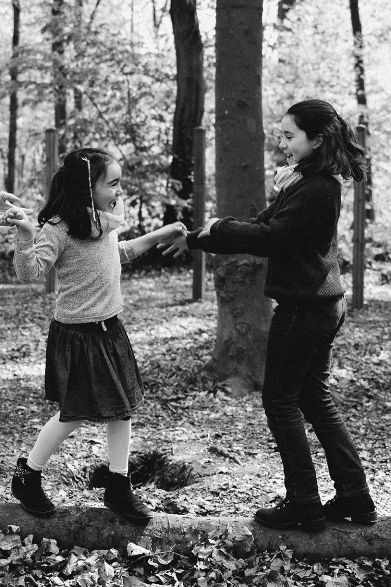 photographe famille de deux petites filles qui jouent en forêt à Paris